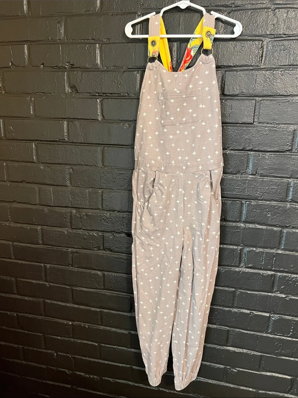 Matilda Jane Taupe One-Piece Overalls with White Cross Print and Yellow Straps